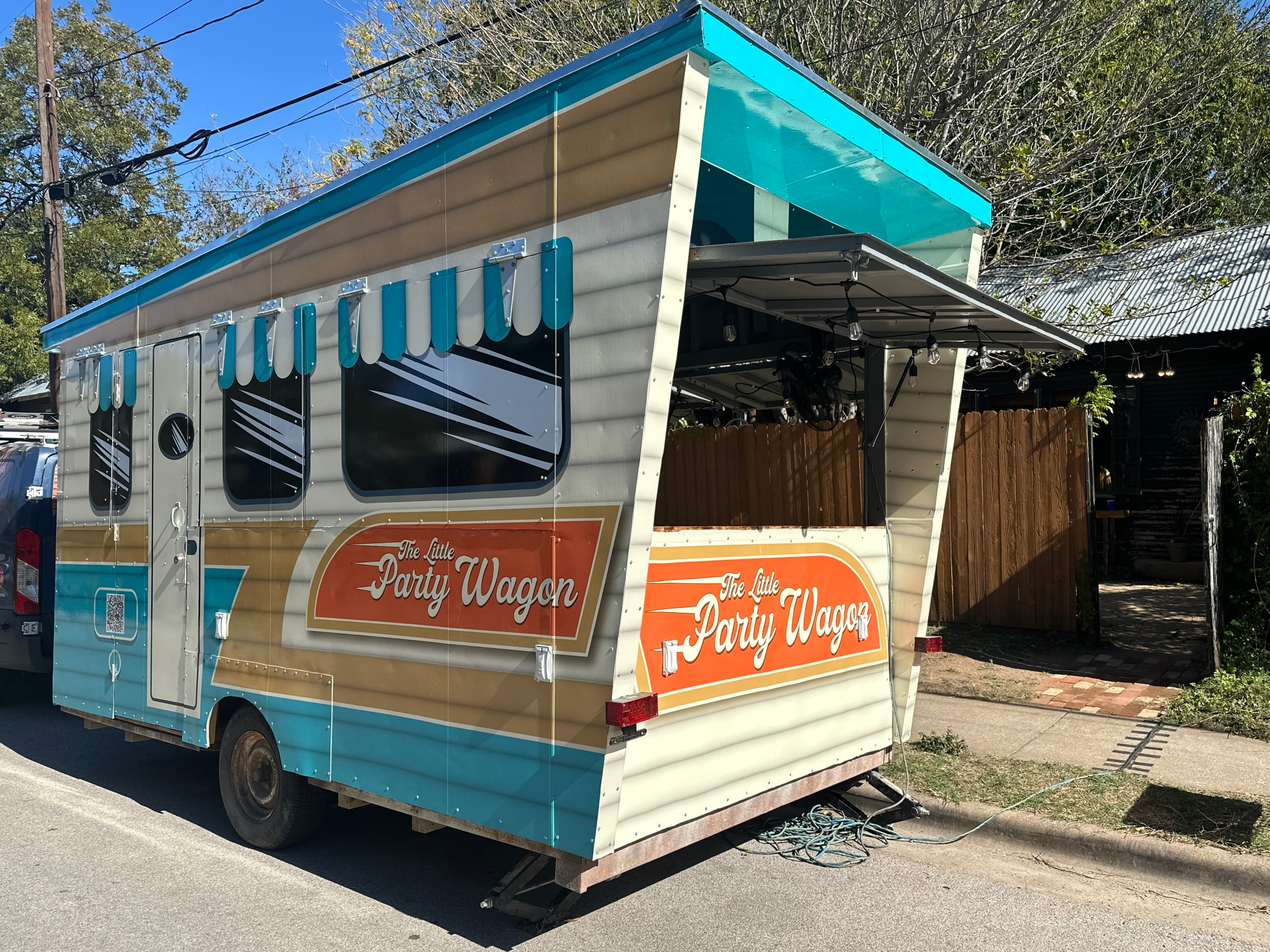 shoe-repair-23 Airstream trailer with wooden table and chairs outside
